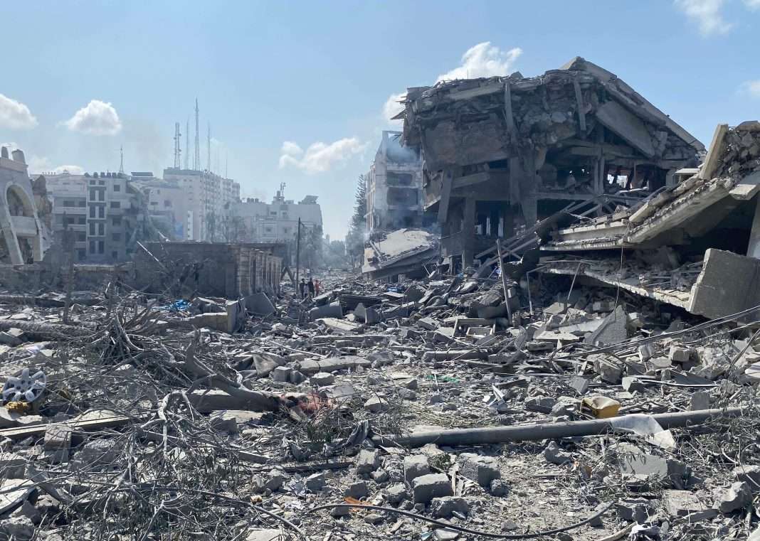 Palestinians inspect the damage following an Israeli airstrike on the El-Remal area in Gaza City